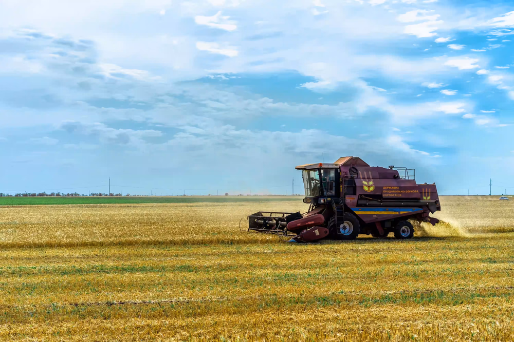 Agricultural combine in Ukrainian field